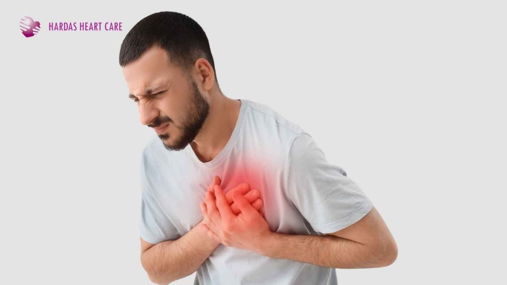 Young Indian adult experiencing chest pain with a cardiologist explaining the causes and prevention of heart attacks in younger individuals.