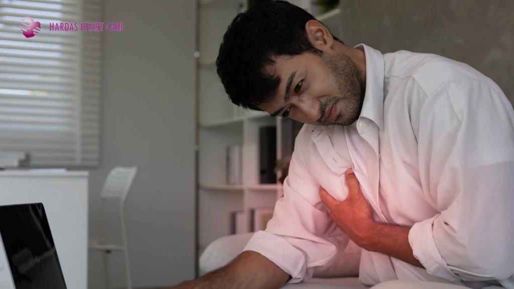 Person experiencing chest pain while recognizing the early warning signs of a heart attack.